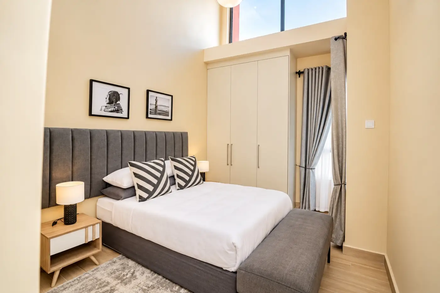 Second bedroom with striped cushions and built-in wardrobe